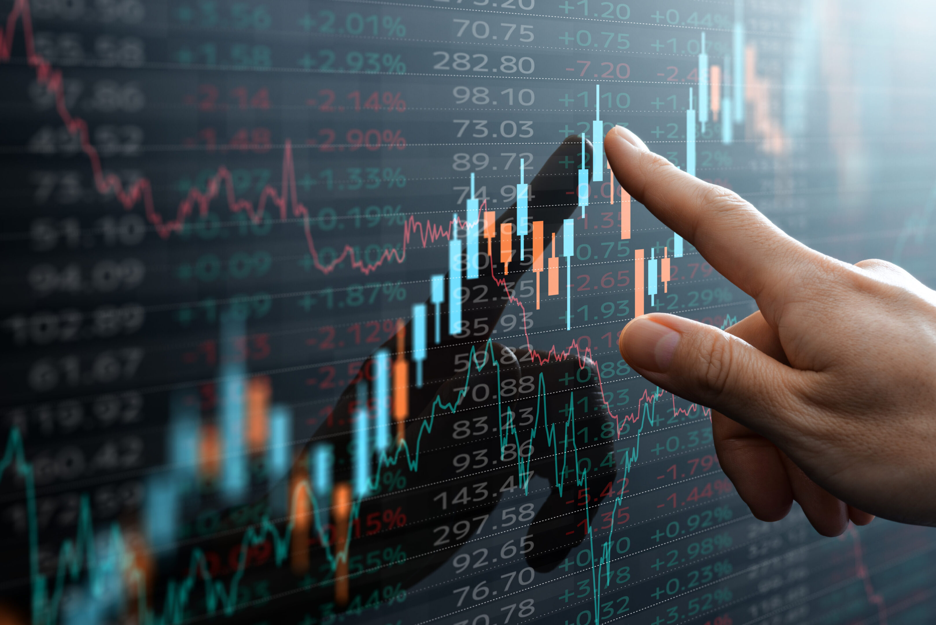 Candlestick chart and data of financial market. Analyst pointing the chart.